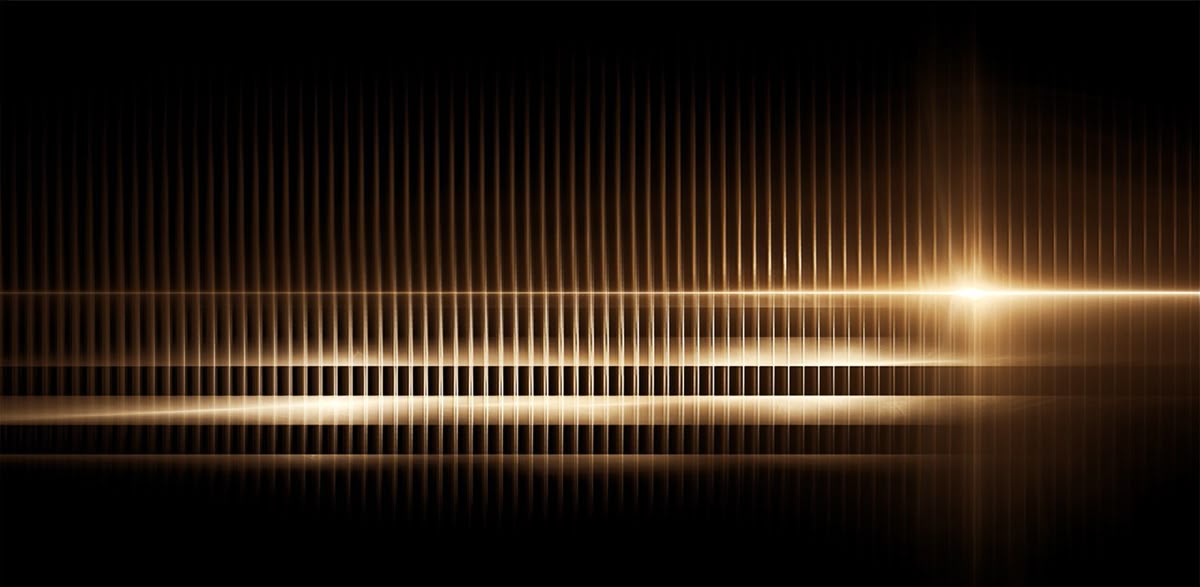 Fine threads of golden light crossing a dark field.